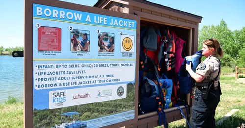 Close‑up of life jackets neatly arranged on a rack